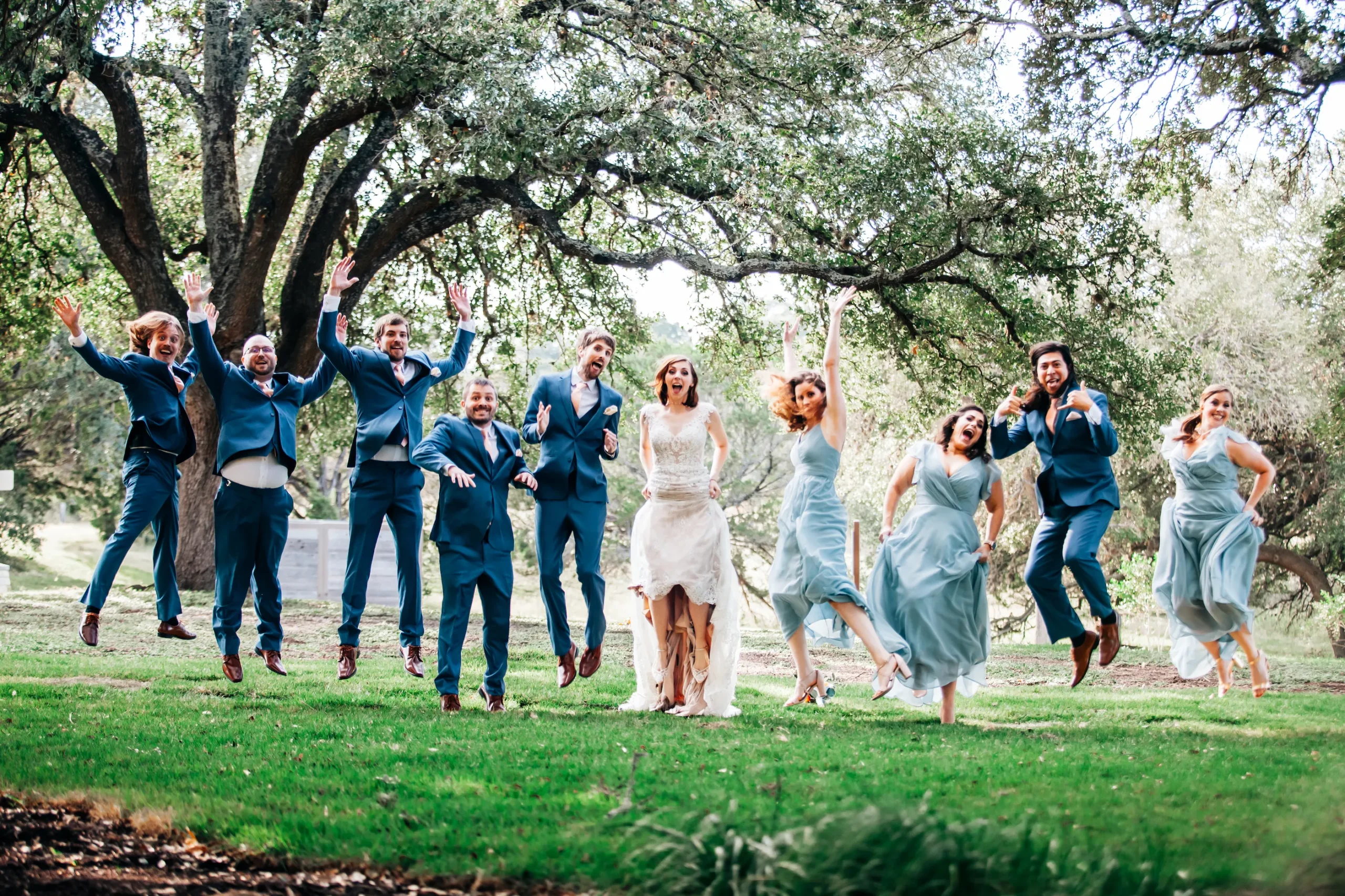 a wedding party jumps into the air