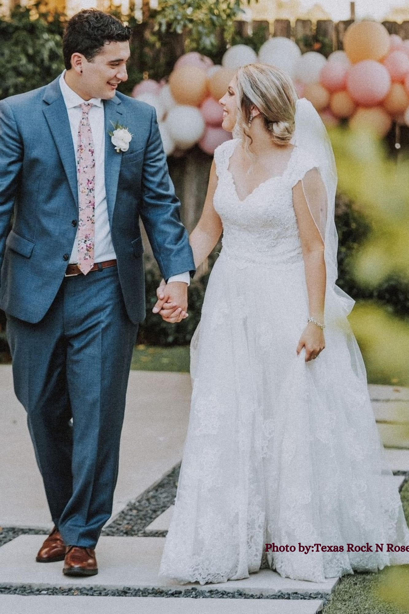 a bride and groom pose on a beach