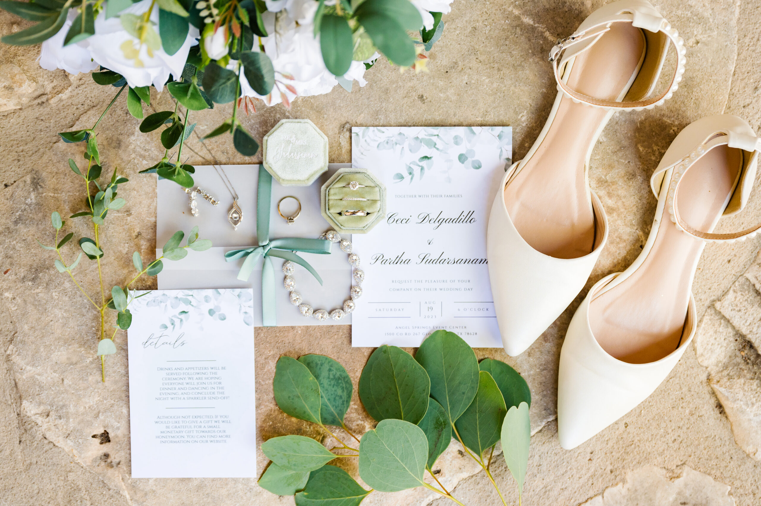 A green and beige invitation suite with wedding shoes