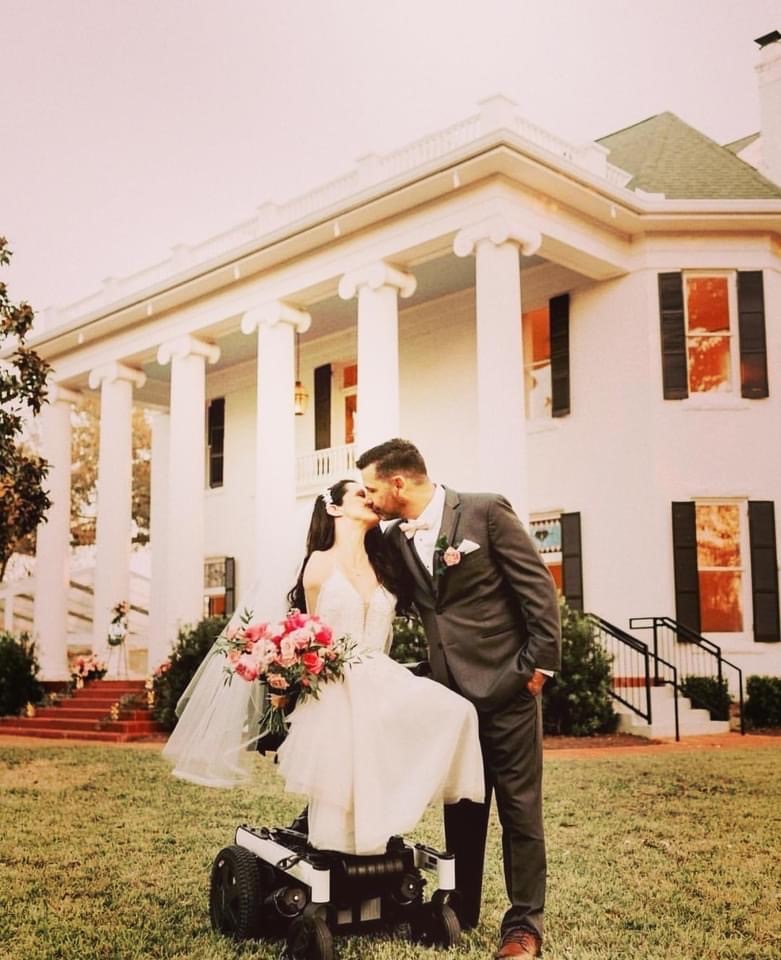 A couple kisses after their wedding ceremony at Woodbine Mansion